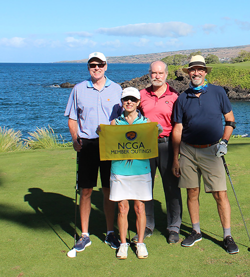 golfers in hawaii holding flag 